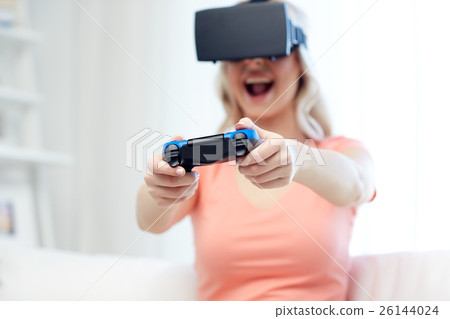 woman in virtual reality headset with controller 26144024