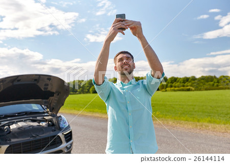 man with smartphone and broken car at countryside 26144114