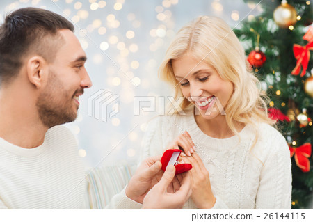 man giving woman engagement ring for christmas 26144115