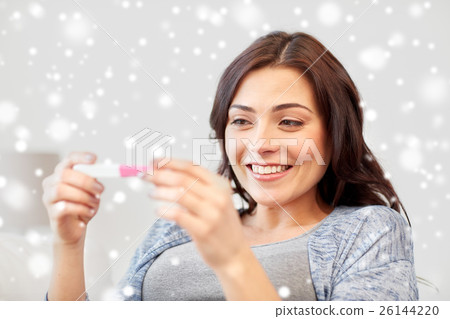 happy woman looking at home pregnancy test happy woman looking at home pregnancy test 26144220