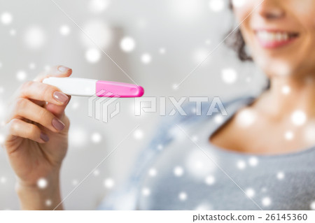 close up of happy woman with home pregnancy test 26145360