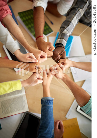 group of international students making fist bump 26145595
