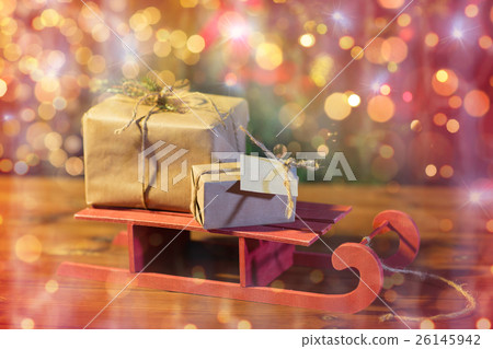 close up of christmas gift boxes on wooden sleigh 26145942