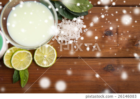 citrus body lotion in bowl on wood 26146083