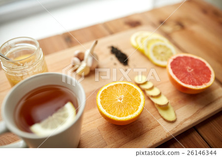 ginger tea with honey, citrus and garlic on wood ginger tea with honey, citrus and garlic on wood 26146344
