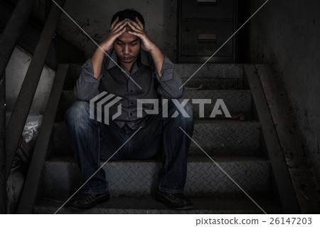 depressed businessman sitting on the stairs. 26147203