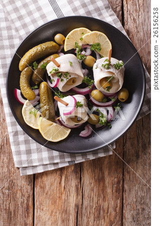 rolls of marinated herring with olives, onions 26156258