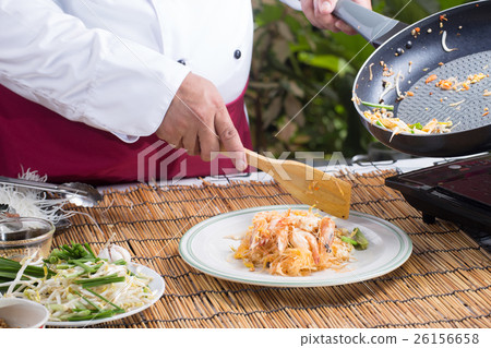 Chef putting Pad Thai to the plate Chef putting Pad Thai to the plate 26156658