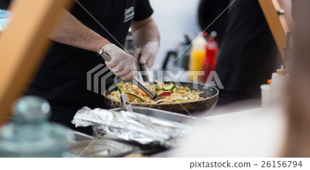 Cheff cooking on outdoor street food festival. Cheff cooking on outdoor street food festival. 26156794