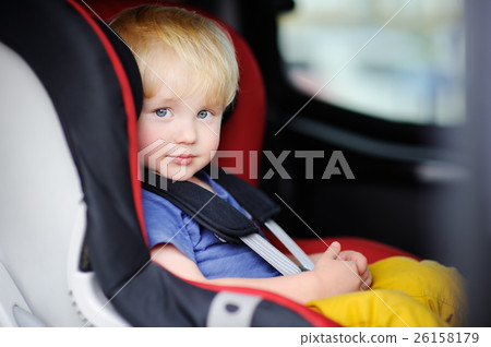 Pretty toddler boy sitting in car seat Pretty toddler boy sitting in car seat 26158179