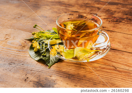 Cup of tea and linden on wooden background 26160298
