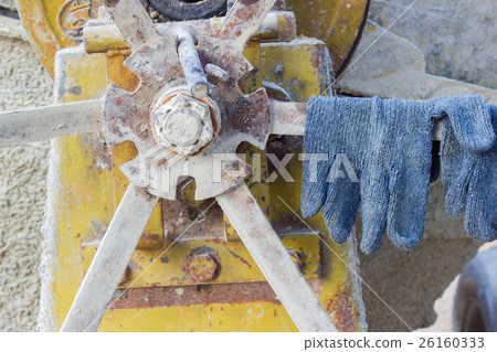 pair of gloves on the cement mixer 26160333