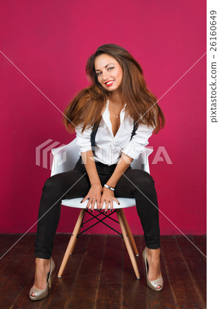 Sexy young woman in white shirt posing on pink 26160649