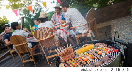 Family having a barbecue party in their garden 26161896