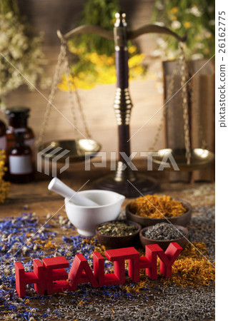 Healthy herbs on wooden table, mortar  26162775