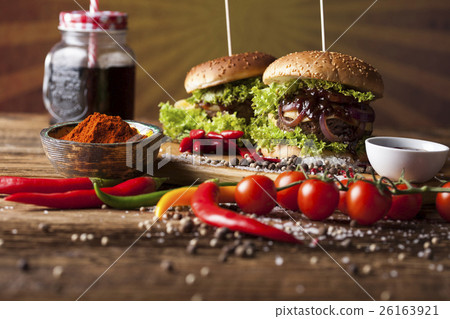 Home made burgers on wooden background. 26163921