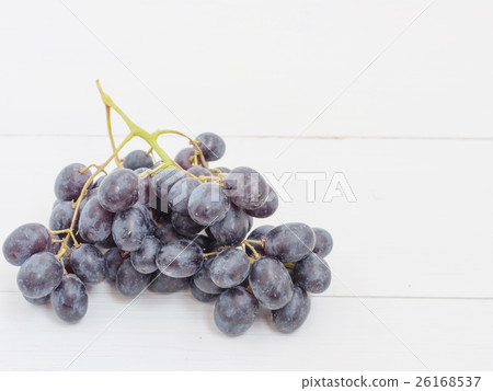 Purple grapes on wooden table 26168537