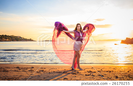 pregnant woman in purple dress posing on beach pregnant woman in purple dress posing on beach 26170255