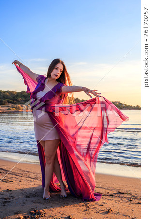 pregnant woman in purple dress posing on beach pregnant woman in purple dress posing on beach 26170257