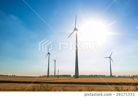 Wind turbine against sky with sun 26171331