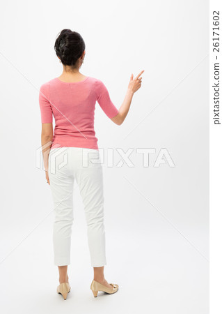 A woman standing backwards with her finger 26171602
