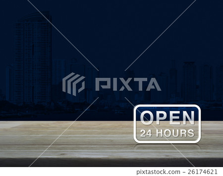 Open 24 hours icon on wooden table over city tower 26174621