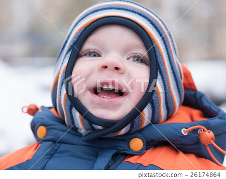 Attractive baby boy playing with the first snow 26174864
