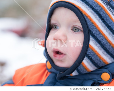 Attractive baby boy playing with the first snow Attractive baby boy playing with the first snow 26174868