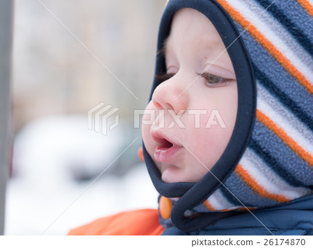 Attractive baby boy playing with the first snow 26174870