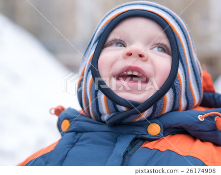 Attractive baby boy playing with the first snow Attractive baby boy playing with the first snow 26174908