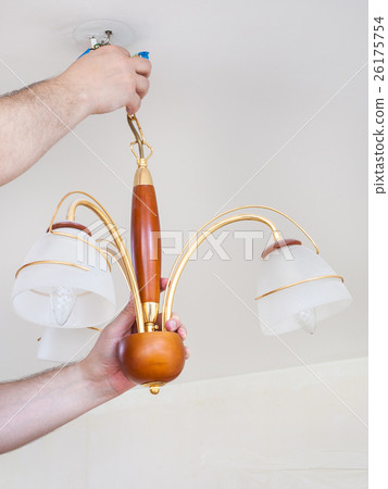 electrician removes ceiling chandelier for repair electrician removes ceiling chandelier for repair 26175754