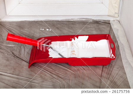 tray with white paint and roller on the windowsill 26175756
