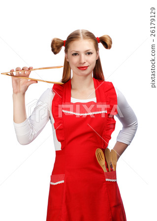 Young housewife in bright red apron with funny ponytails holding 26179129