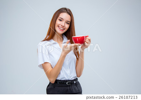 The young business woman on gray background The young business woman on gray background 26187213
