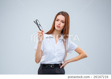 The young business woman on gray background The young business woman on gray background 26187216