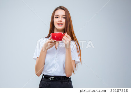 The young business woman on gray background The young business woman on gray background 26187218
