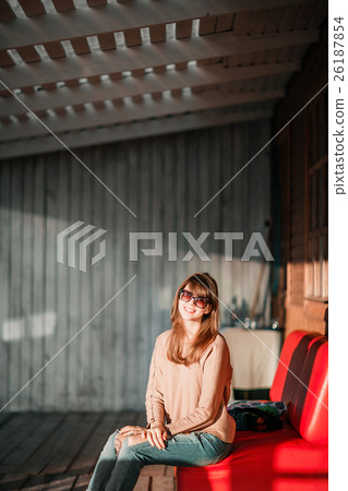 young modern girl on veranda. sunset evening in 26187854