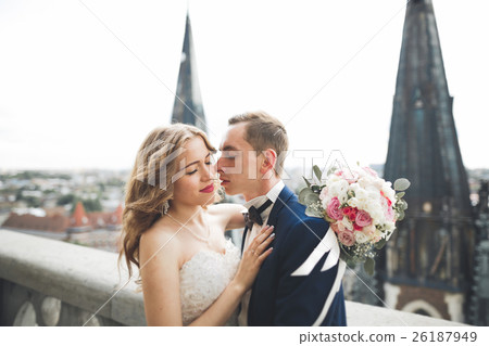 Stylish beautiful wedding couple kissing and 26187949