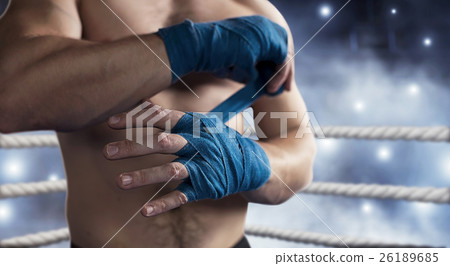 Boxer pulls bandage before the fight or training. 26189685