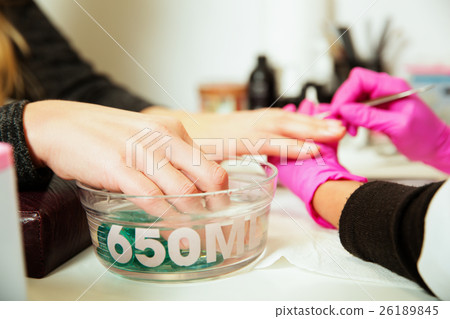 Manicure procedure with female hands. 26189845