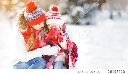happy family mother and child on winter walk drinking tea happy family mother and child on winter walk drinking tea 26198220