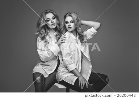 Two beautiful girls in white shirts and jeans Two beautiful girls in white shirts and jeans 26200448