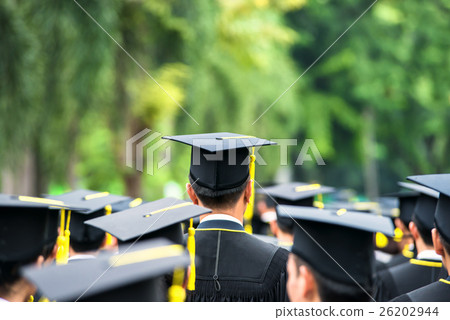 Back of graduates during commencement . 26202944
