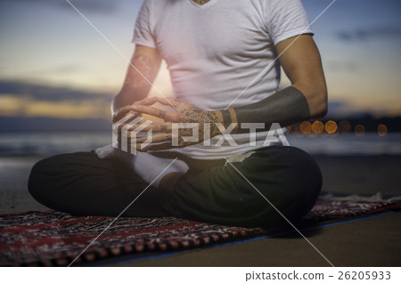 Man sitting in lotus position on the beach Man sitting in lotus position on the beach 26205933