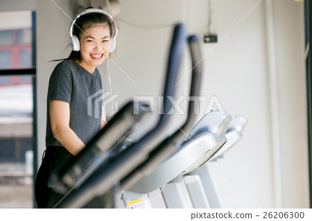 Asian woman exercising at the gym on cross trainer 26206300