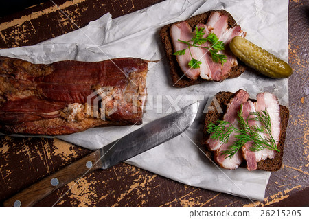 Smoked bacon with black bread and several pickles 26215205