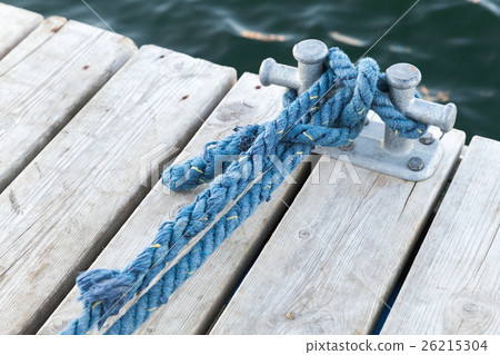Mooring bollard with tied blue rope 26215304