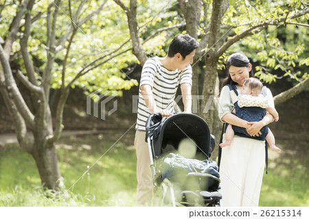 Babies and parents taking a walk in the park 26215314