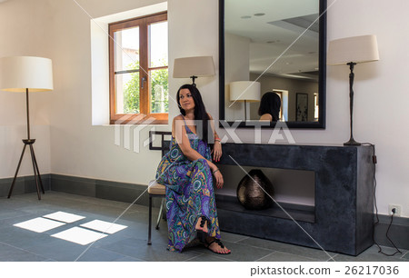 beautiful young brunet woman in blue dress 26217036