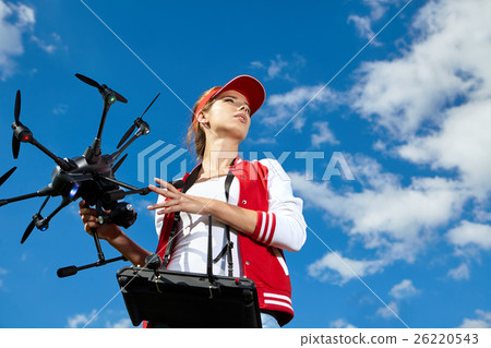 Woman is standing and holding drone 26220543